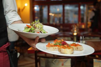 Restaurant Server holding two plates of food