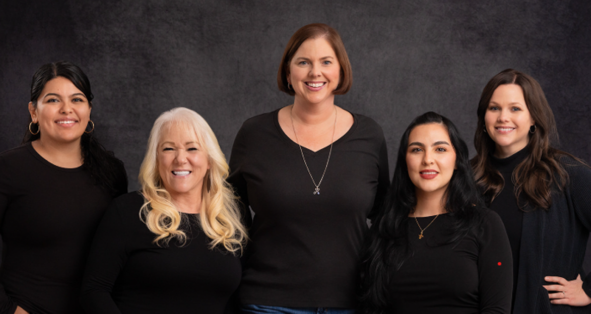 5 team members smiling