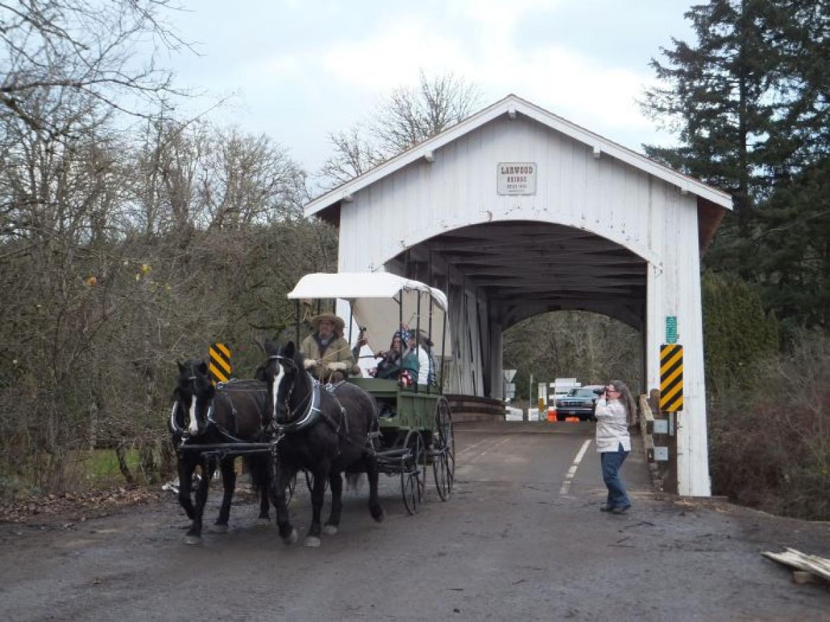 Horse-drawn carriage over Larwood Covered Bridge