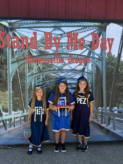 Pez girls in front of Stand By Me sign